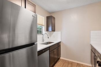 an empty kitchen with stainless steel appliances and a sink at 300 Riverside Apartments, Austell, 30168